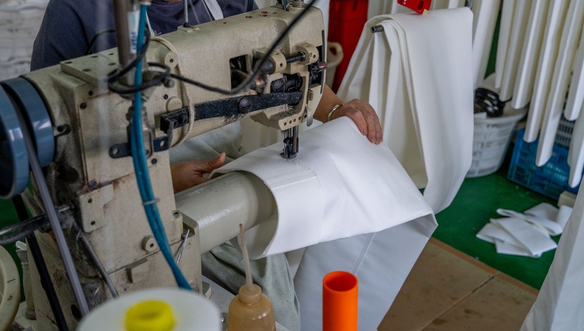 Close review of PTFE filter bag stitching and seam alignment.