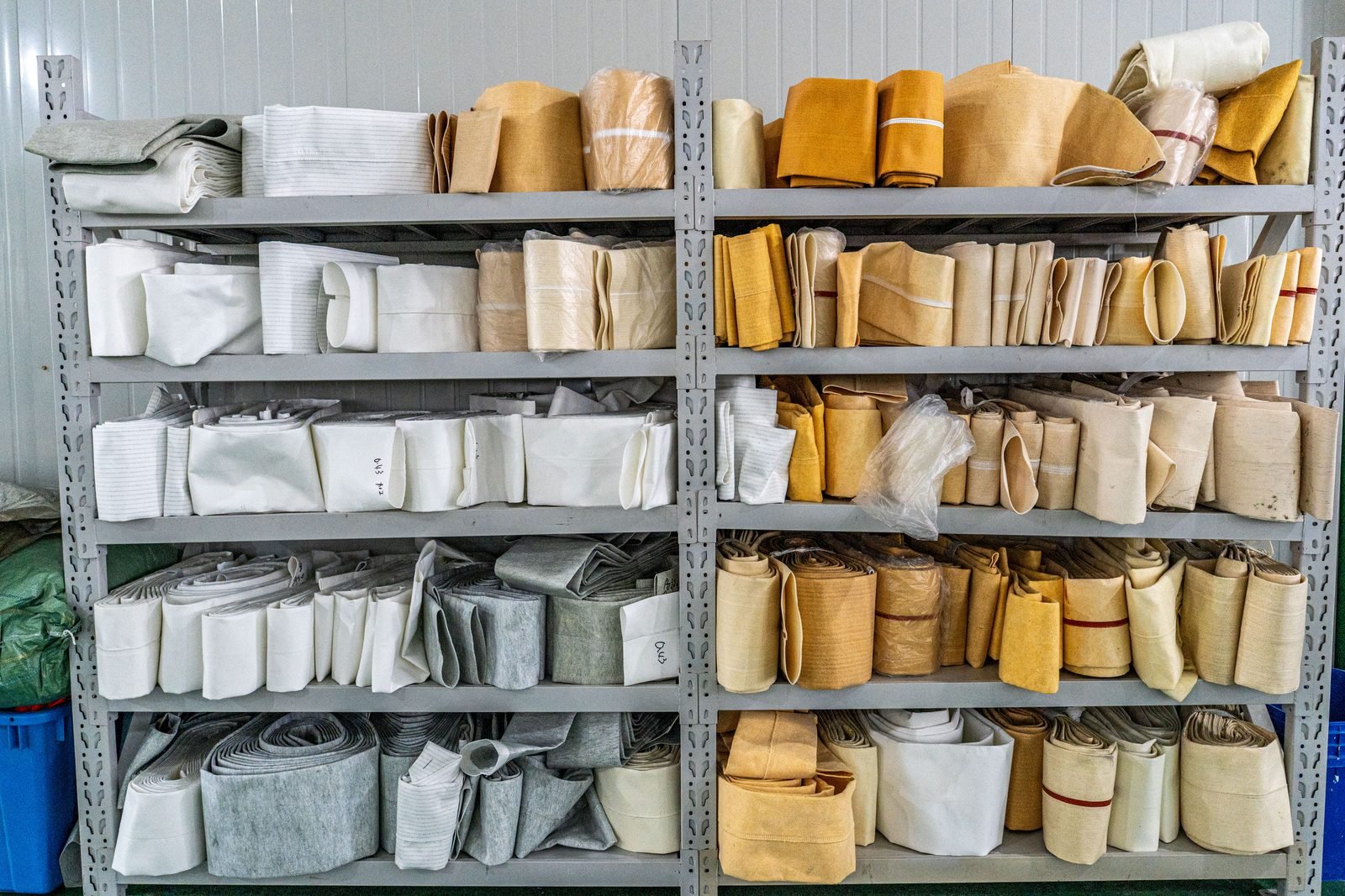 Different filter bag constructions stored for material and size reference.