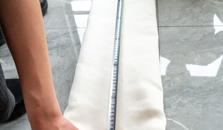 Measuring an old dust collector filter bag before replacement