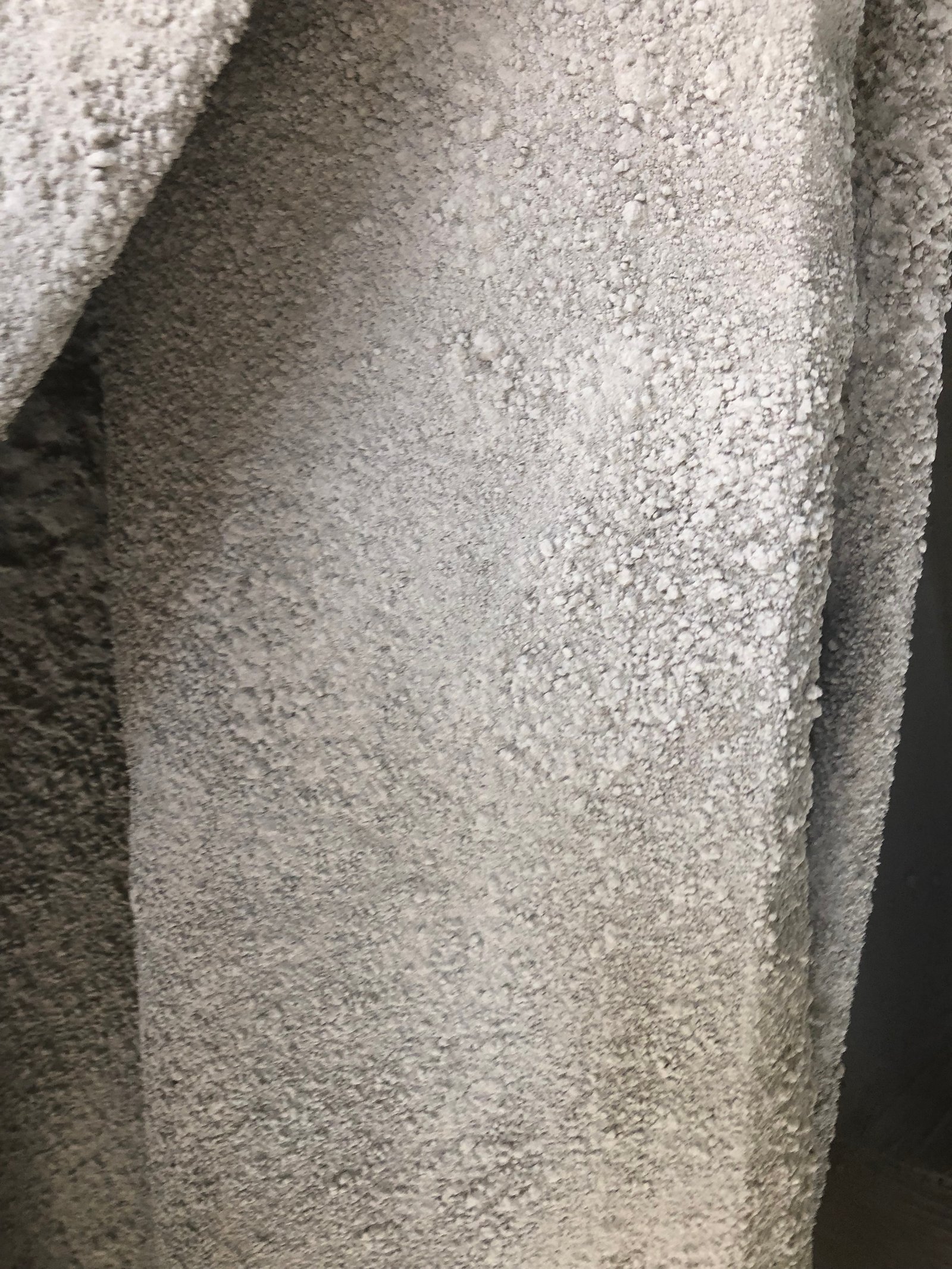Comparable close view of a filter bag with hard plate-like deposits