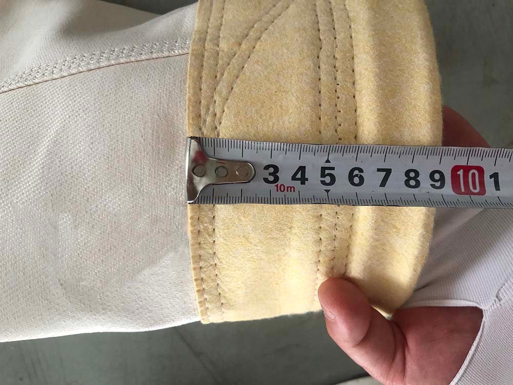 Close-up dimensional inspection of a finished filter bag cuff and seam