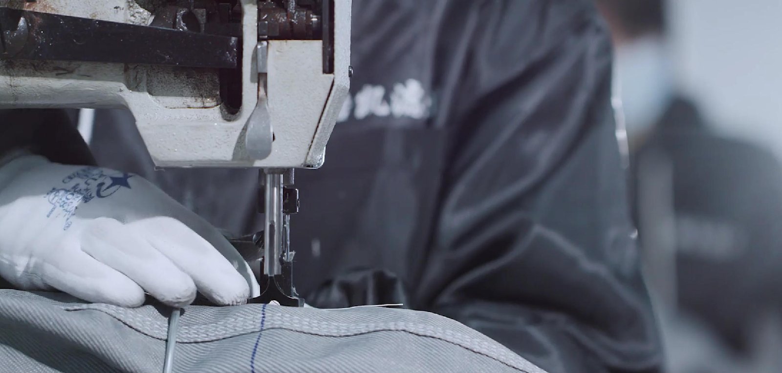 Close view of industrial filter bag sewing during manufacturing